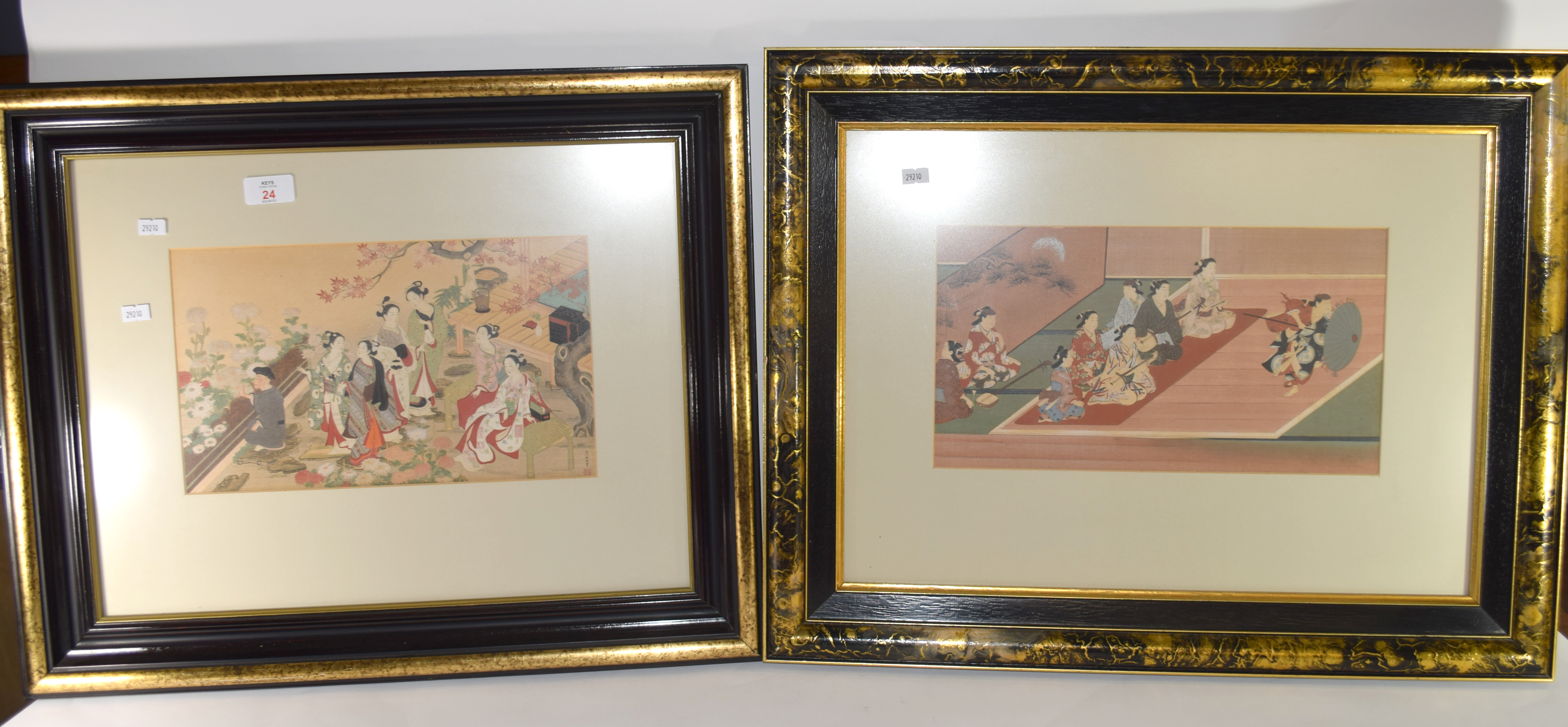 Two Japanese woodblock framed prints of figures in various pursuits in black wooden frames, the