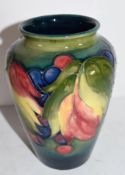 Moorcroft vase in the leaf and berry tube lined design on green ground, 15cm high