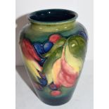 Moorcroft vase in the leaf and berry tube lined design on green ground, 15cm high