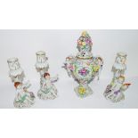 Small Continental porcelain vase floral decoration with handles flanked by cherubs, the cover with