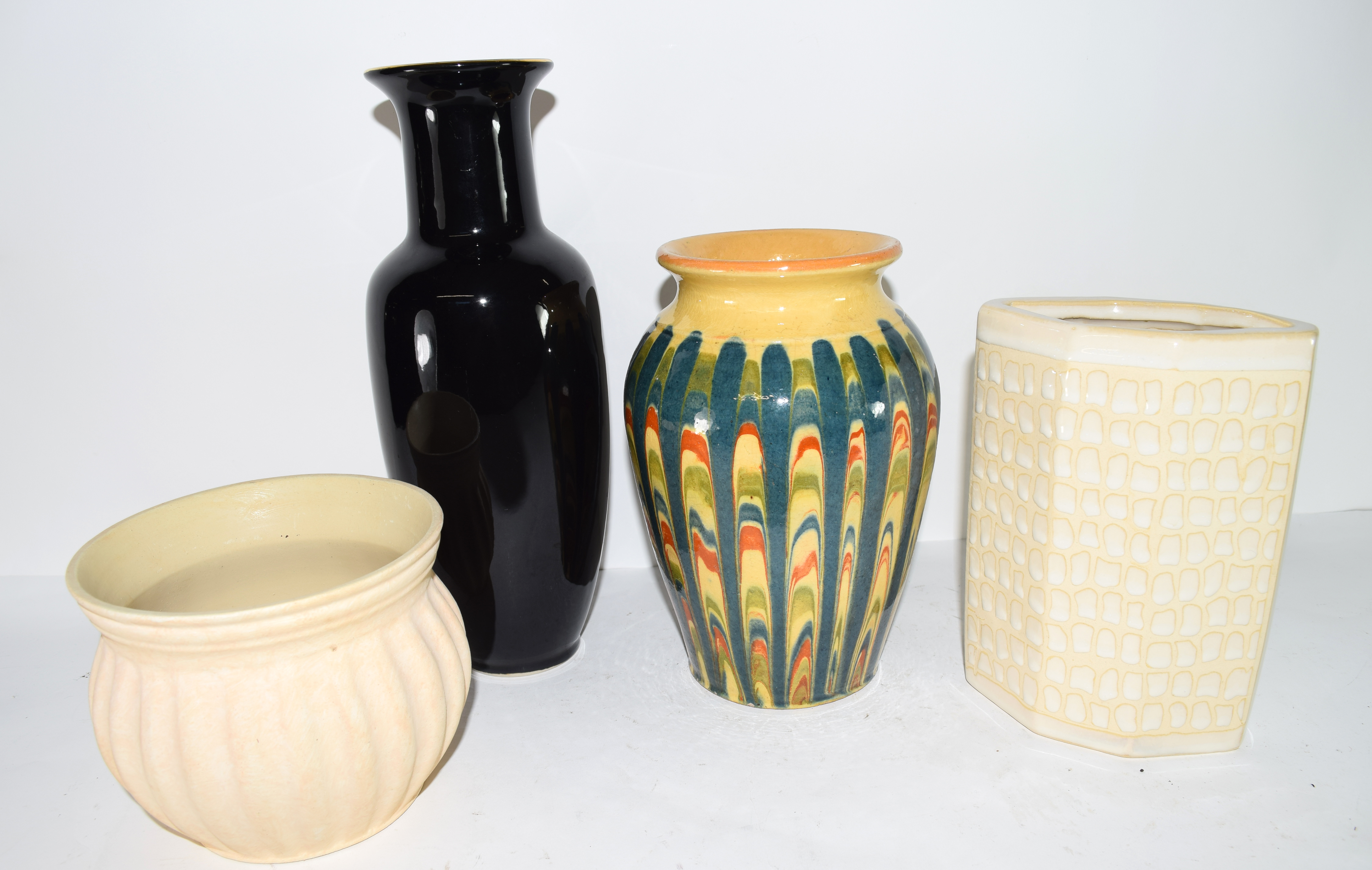 Group of four pottery vases of various shapes and designs