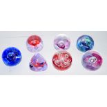 Quantity of seven small paperweights with various designs