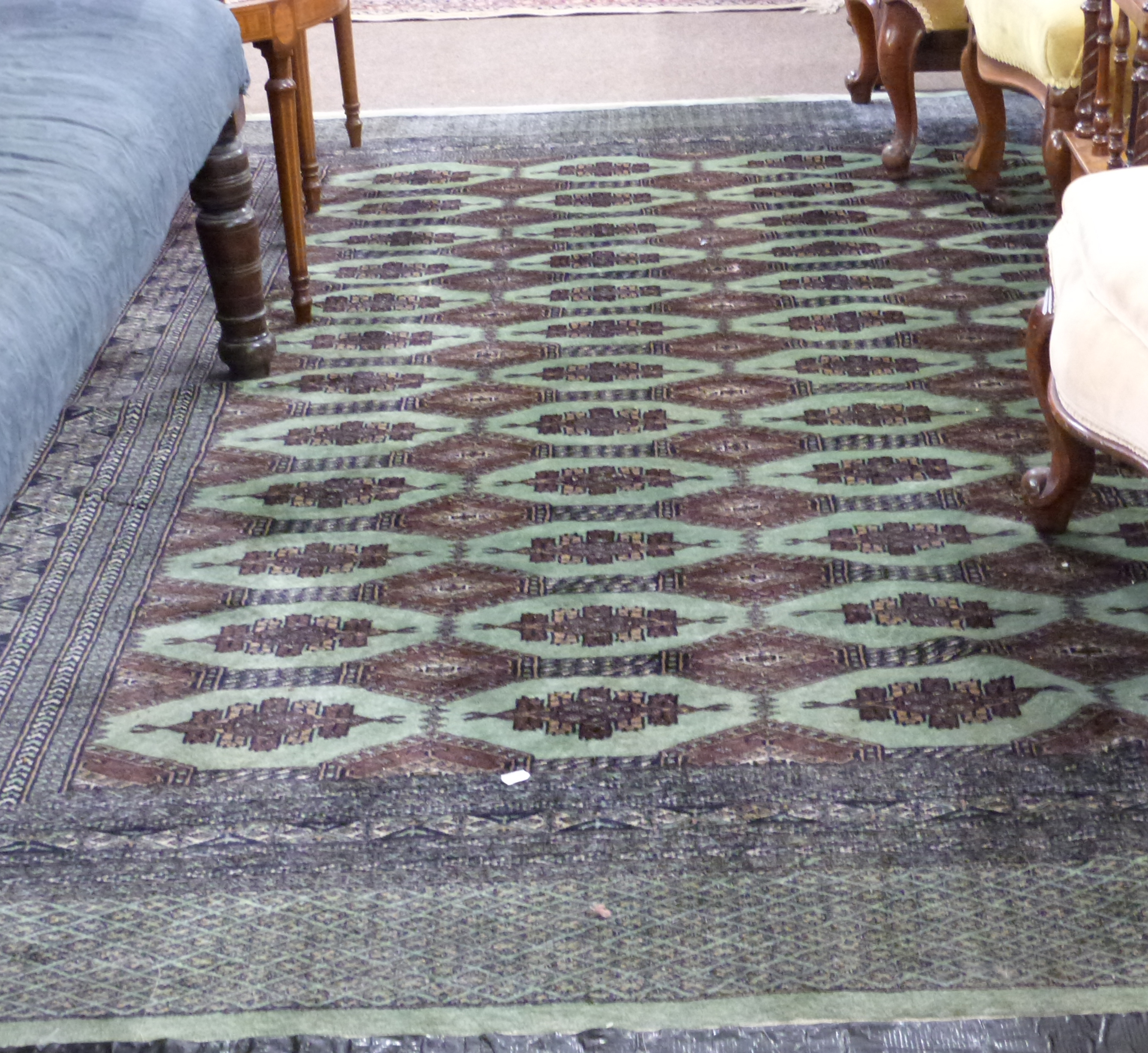 Green and Brown patterned wool carpet, decorated with medallions and a gulled border, 9ft x 5ft8 - Image 2 of 2