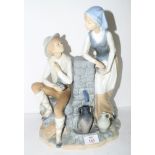 Large Lladro figure of a young boy and girl by a well on a shaped base