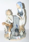 Large Lladro figure of a young boy and girl by a well on a shaped base