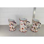 GRADUATED SET OF THREE HAND DECORATED WATER JUGS, LARGEST APPROX 22CM