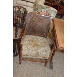 CANE BACK UPHOLSTERED ARMCHAIR WITH CARVED DECORATION, WIDTH APPROX 54CM