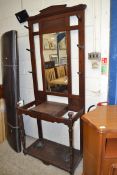 LATE 19TH/EARLY 20TH CENTURY MAHOGANY HALL STAND WITH CENTRAL BEVELLED MIRROR, SUPPORTED ON TURNED