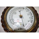 EARLY 20TH CENTURY ANEROID BAROMETER SET IN AN OAK ROPE FORMED CASE