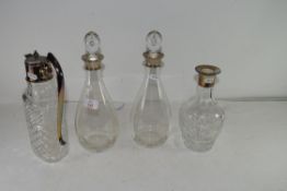 MIXED LOT: PAIR OF DECANTERS WITH SILVER COLLARS PLUS A NON-MATCHING CLEAR GLASS DECANTER WITH