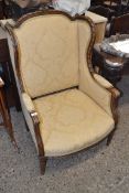 LATE 19TH CENTURY CONTINENTAL WING BACK ARMCHAIR WITH CARVED SHOW WOOD FRAME, UPHOLSTERED IN FLORAL