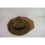 VINTAGE GREEN MILITARY WIDE BRIMMED HAT SET IN A WOODEN SURROUND