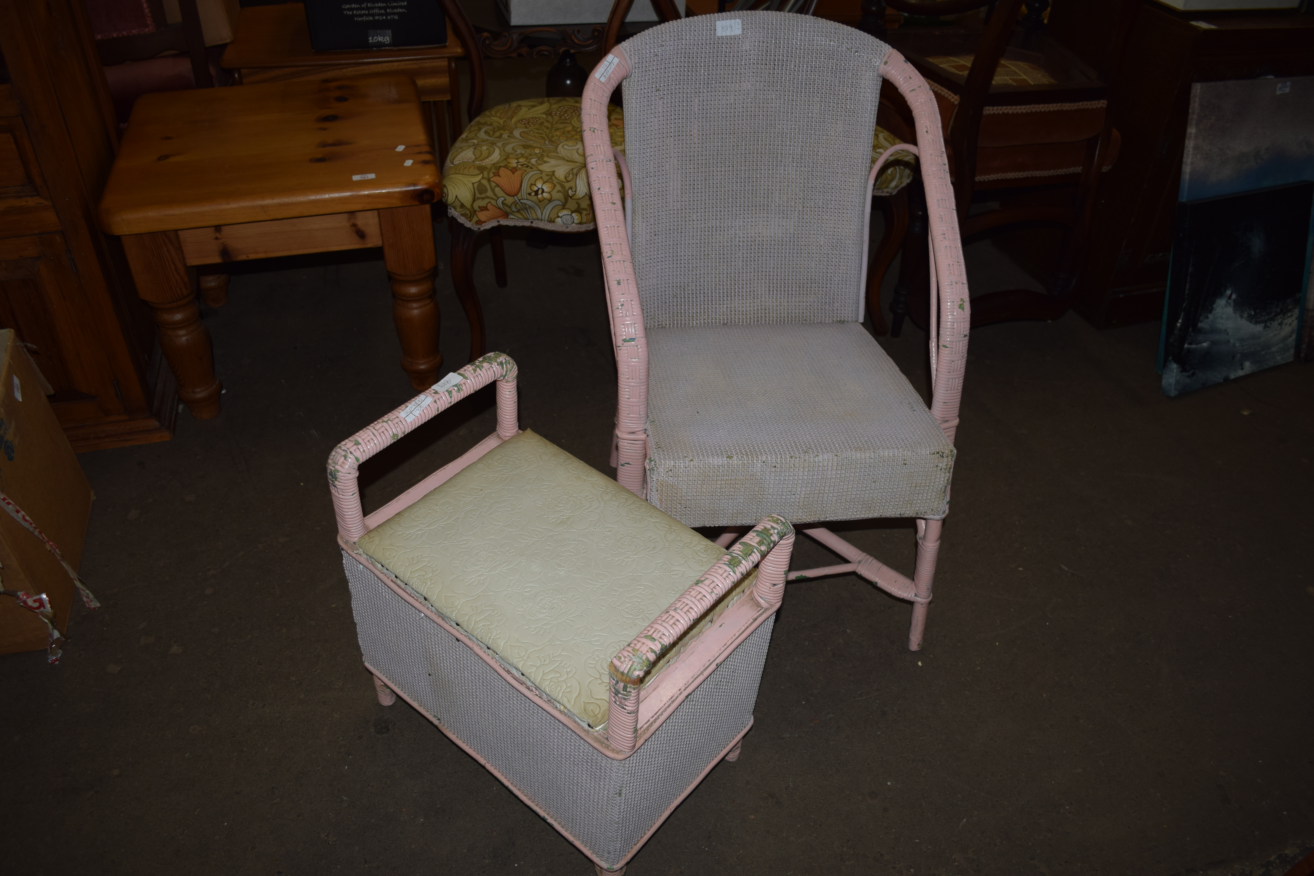 A PINK PAINTED WICKER CHAIR AND ACCOMPANYING FLIP-TOP STOOL