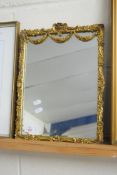 20TH CENTURY GILT FRAMED WALL MIRROR DECORATED WITH FLORAL AND SWAG DETAIL