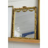 20TH CENTURY GILT FRAMED WALL MIRROR DECORATED WITH FLORAL AND SWAG DETAIL