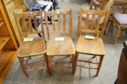 THREE STAINED BEECHWOOD SLAT BACK SIDE CHAIRS