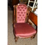 VICTORIAN BUTTON BACK VELOUR UPHOLSTERED NURSING CHAIR WITH SHOWOOD FRAME RAISED ON TURNED LEGS,