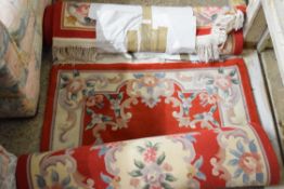 TWO CHINESE WOOL FLOOR RUGS WITH FLORAL DECORATION ON A RED AND BEIGE BACKGROUND