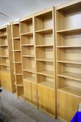 SUITE OF LIGHT OAK FINISH SHELVING COMPRISING THREE NARROW SHELVES WITH CUPBOARD BASES, ONE WIDE