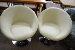 PAIR OF MODERN CREAM LEATHER TUB CHAIRS, RAISED ON METAL BASES