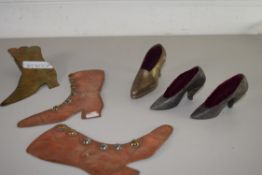 THREE BASE METAL PIN CUSHIONS FORMED AS HIGH HEEL SHOES TOGETHER WITH THREE FURTHER COPPER AND BRASS