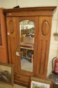 LATE VICTORIAN AMERICAN WALNUT WARDROBE WITH SHAPED CORNICE OVER A SINGLE MIRRORED DOOR AND DRAWER