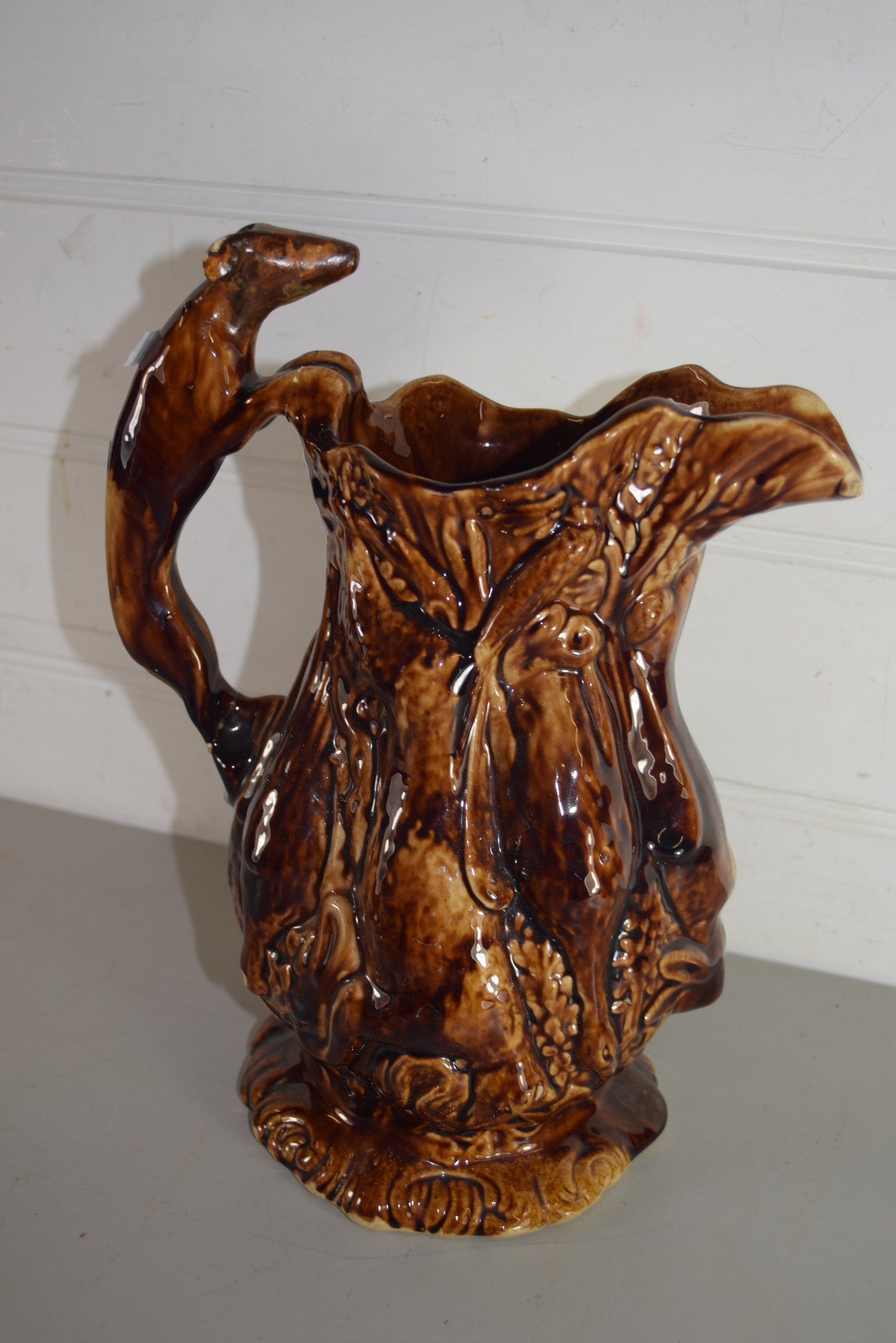 TREACLE GLAZE JUG DECORATED WITH DEAD GAME