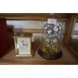 DOME TOP ANNIVERSARY CLOCK AND A QUARTZ OPERATED CARRIAGE CLOCK