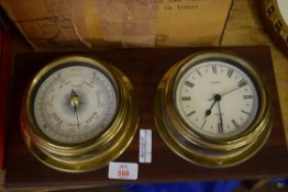 REPRODUCTION BRASS CASED QUARTZ SHIPS CLOCK AND ACCOMPANYING BAROMETER ON WOODEN BACKING