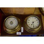 REPRODUCTION BRASS CASED QUARTZ SHIPS CLOCK AND ACCOMPANYING BAROMETER ON WOODEN BACKING