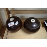 TWO HARDWOOD LAWN BOWLS