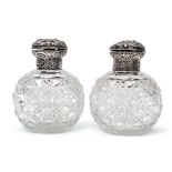 Pair of late Victorian hobnail cut oval glass scent bottles, the hinged lids and collars heavily