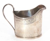 George III silver cream jug of oval form fitted with looped handle and decorated with floral detail,