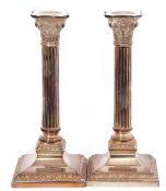 Pair of 20th century silver candlesticks of Corinthian column form on square loaded bases, marked to