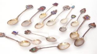 A collection of 14 20th century silver and enamelled collectors spoons from various parts of the