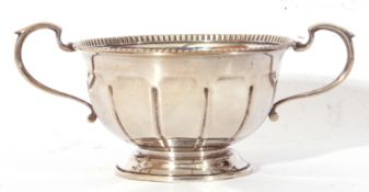 George V silver circular double handled sugar basin raised on a spreading foot, Birmingham 1935,