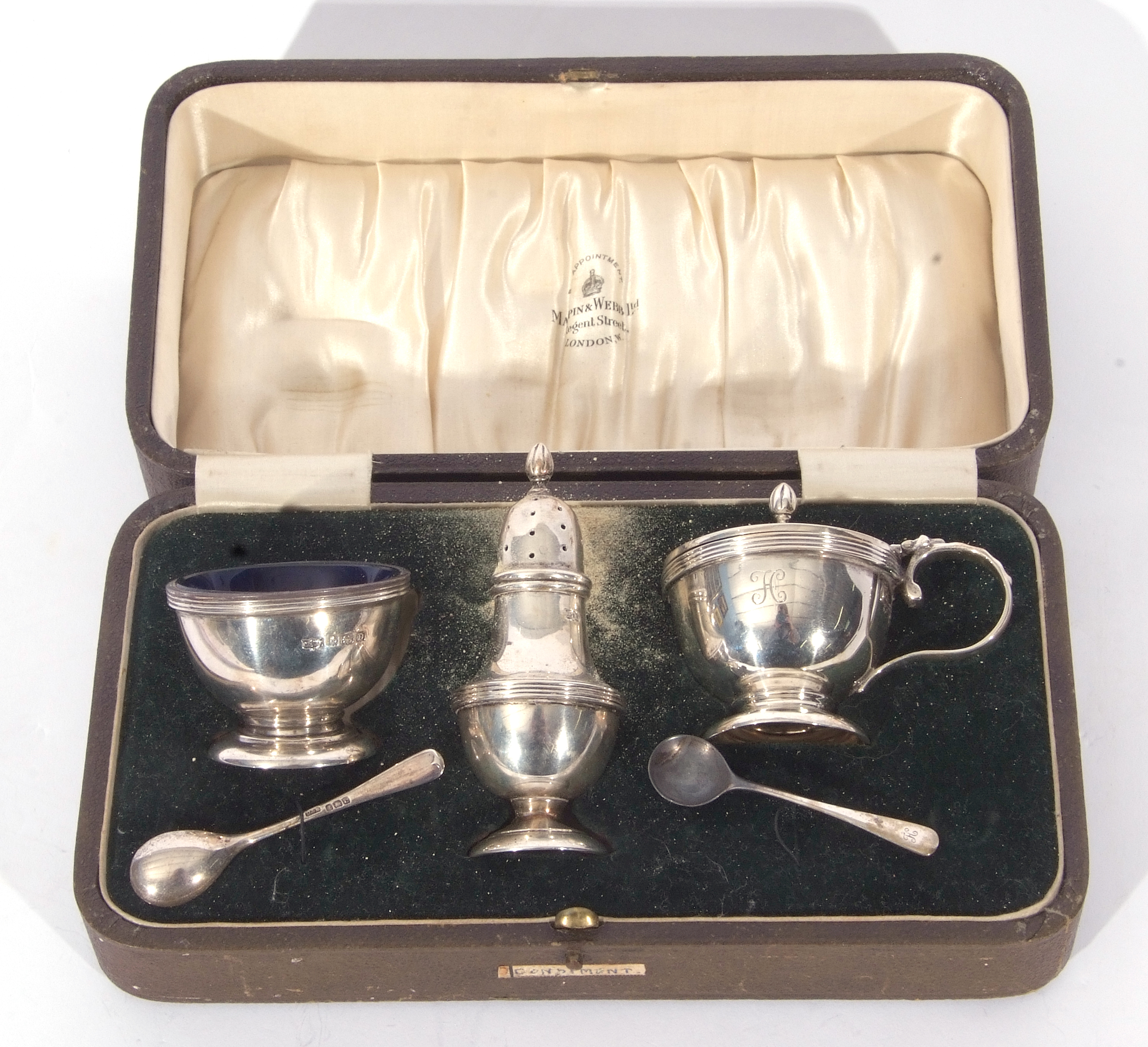 George V silver condiment set comprising baluster pepper pot, circular hinged lid mustard and a