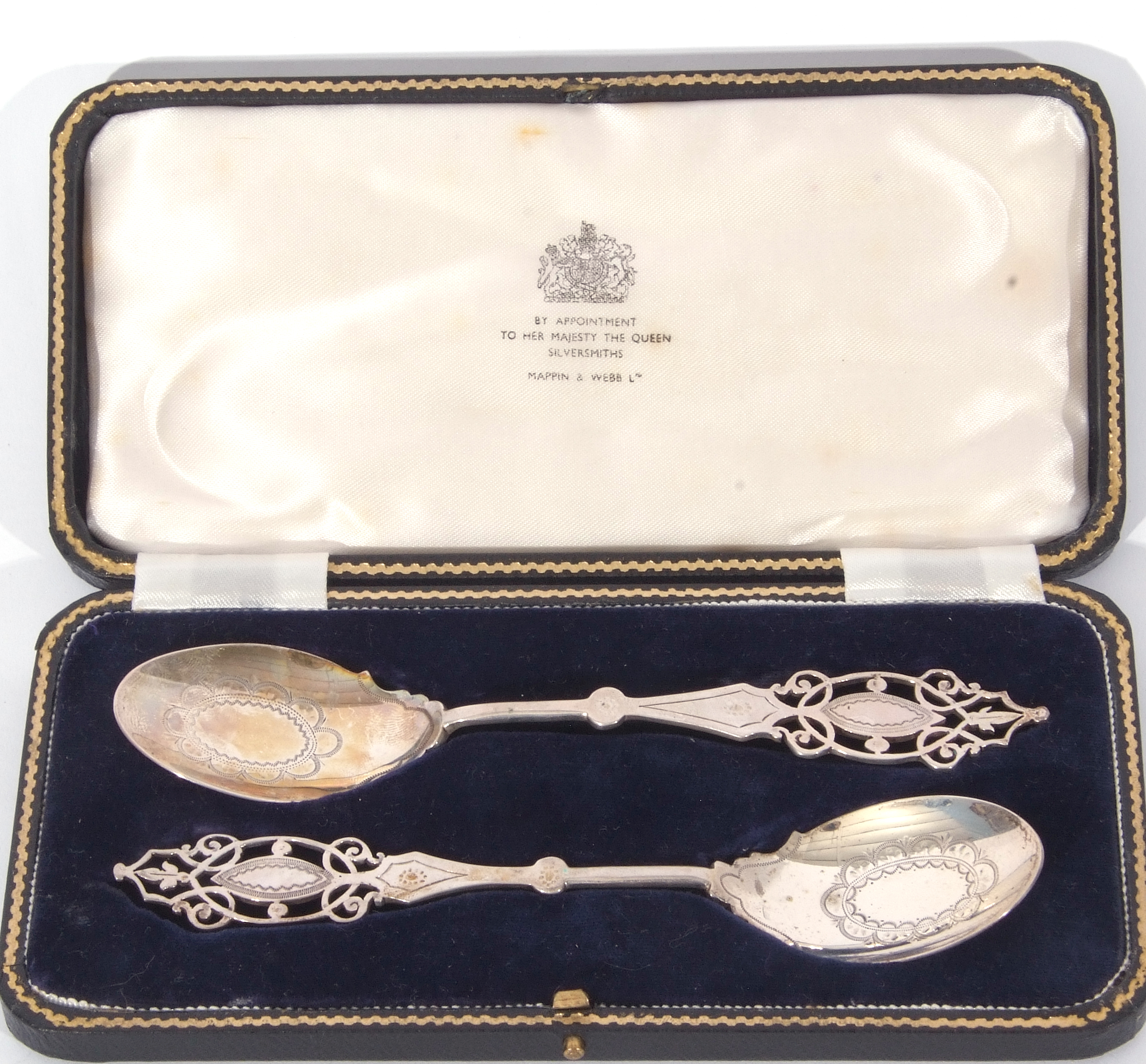 George V cased pair of presentation silver spoons with elegant pierced finials and decorated