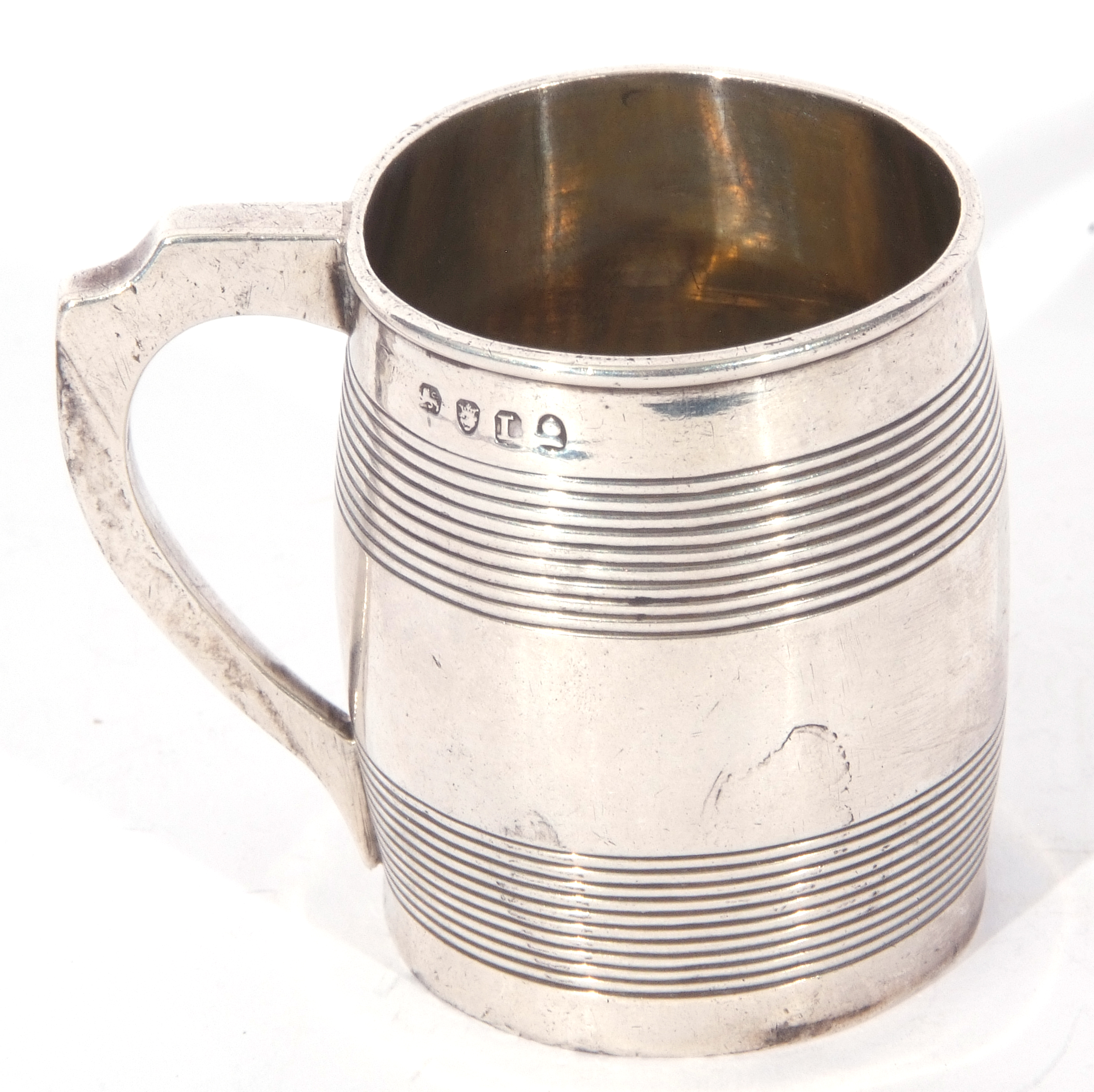 George III silver miniature tankard of circular form with looped handle, the body decorated with