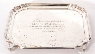 George VI silver card tray with shaped border raised on short swept legs, bearing presentation