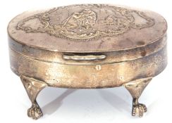 Edward VII silver dressing table box of oval hinged form, the top decorated with figures before a