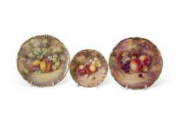 Group of three small Royal Worcester plates, all decorated with fruit, one signed J Skerrett, within