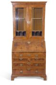 Early Georgian walnut bureau bookcase, the top section with two glazed doors with twin shelves and