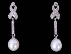 Pair of 18ct white gold, diamond and pearl drop earrings, a design with a small diamond set bow,