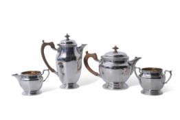 George V three piece silver tea set of panelled circular form with applied friezes comprising tea