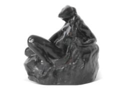 Attributed to Courtenay Pollock (1877-1943), a bronze figure of a reclining female nude on a rocky