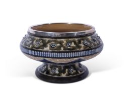 Art pottery pedestal bowl decorated with a green scrolling design and applied florets in Lambeth