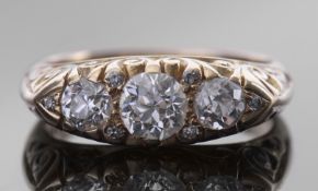 Diamond three stone ring centring a round old cut diamond, 0.65ct approx, flanked by two further old