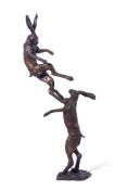 Paul Jenkins', Bronze Fighting Hares, pair of solid bronze fighting hares, 96cm tall, initialled '