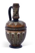 Stoneware Art pottery ewer of baluster form decorated with stylised foliate motifs in brown, green